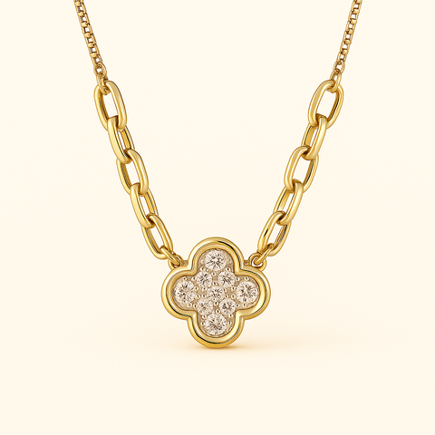 Close-up of a 14K yellow gold clover necklace with pavé diamond accents, featuring a polished gold chain and adjustable clasp.