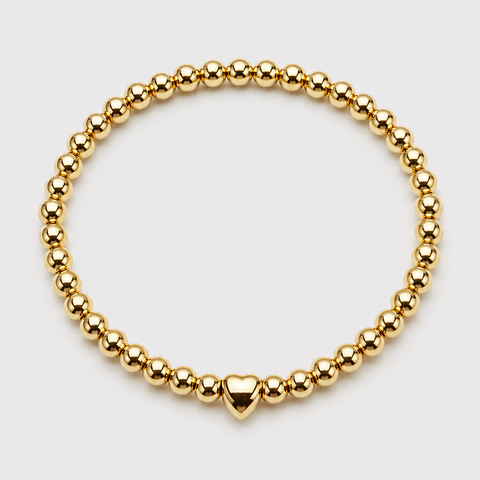 14K yellow gold ball bead stretch bracelet with puffed heart center bead, full bracelet, flat overhead view