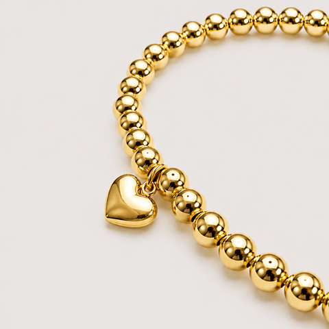 14K yellow gold ball bead stretch bracelet with solid polished puffed heart charm dangle, high polish, close-up front view