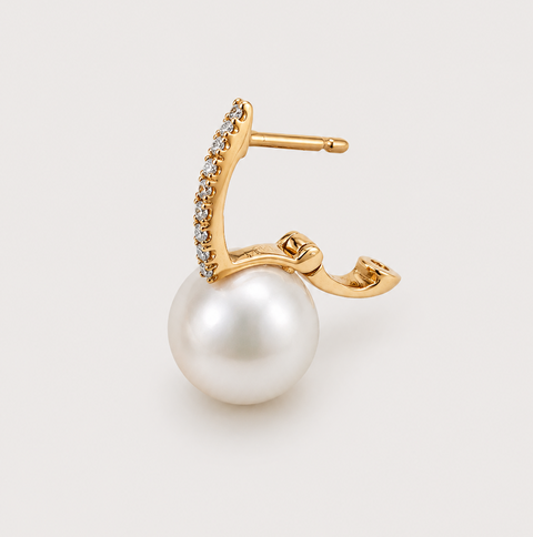 Single 14K yellow gold pavé diamond huggie earring with white pearl drop showing post and open clasp mechanism detail