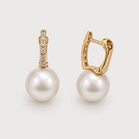 14K yellow gold pavé diamond huggie earrings with white pearl drops angled side view showing lever back mechanism