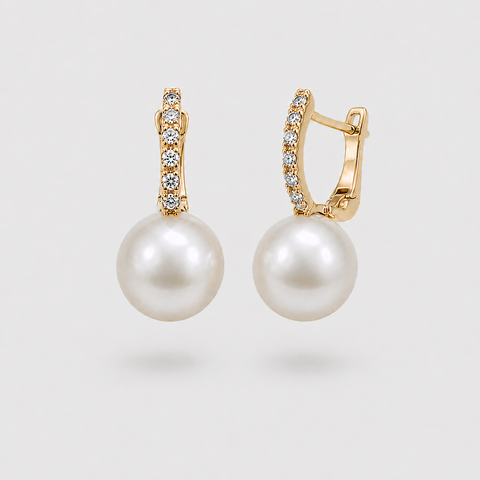 14K yellow gold pavé diamond huggie earrings with white pearl drops floating front view light gray background
