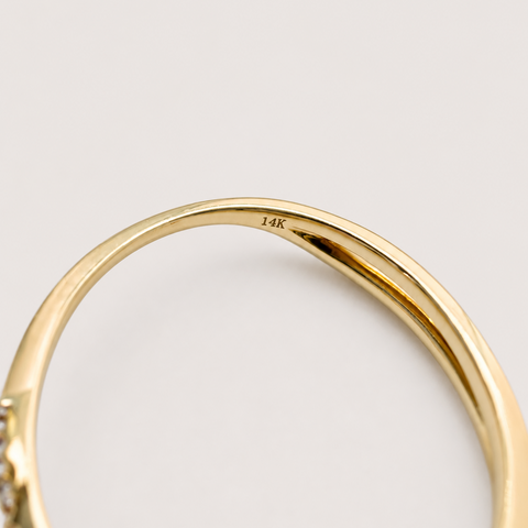 Macro close-up of 14K yellow gold pearl ring interior showing 14K hallmark stamp engraved inside band