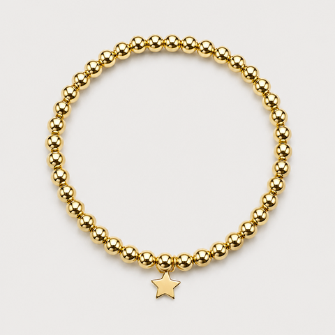 14K yellow gold ball bead stretch bracelet with solid polished star charm dangle, full bracelet, flat overhead view