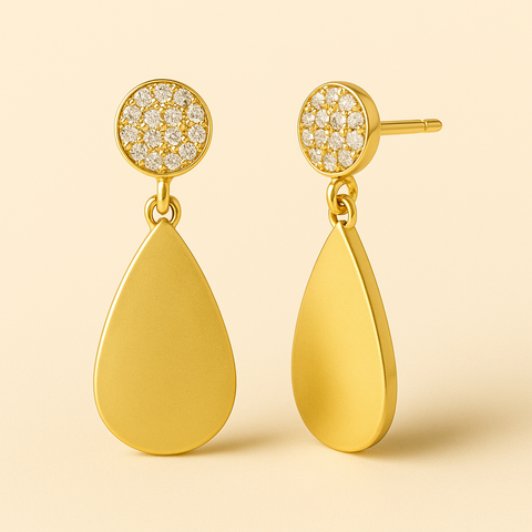 Gold teardrop earrings with diamond-studded tops on a beige background
