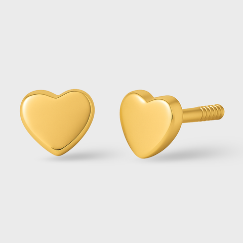 Gold heart-shaped earrings on a light gray background