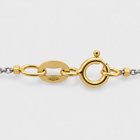 Close-up of the spring ring clasp and 750 gold purity hallmark on the 18K two-tone cube station necklace