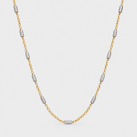 18K two-tone gold station necklace with diamond-cut white gold barrel stations on a delicate yellow gold chain, 17 inch, by Vaskia Jewelry.