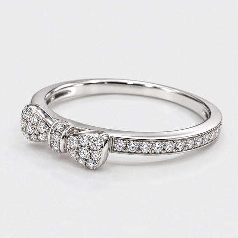Angled view of an 18K white gold pavé diamond bow ring showing its diamond-set band.
