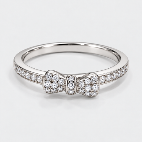 Front view of an 18K white gold bow ring with pavé diamonds across the bow and band.