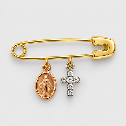 Solid 18K yellow gold safety pin featuring a rose gold Miraculous Medal charm and a white gold diamond cross charm on a polished finish.