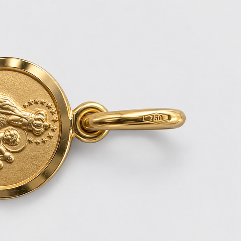 Macro close-up of 18K Italian yellow gold Our Lady of Mount Carmel round medal pendant bail showing 750 hallmark stamp detail