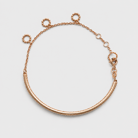 18K rose gold double-row diamond bangle bracelet reverse side, showing back of bar, adjustable chain with beaded ring connectors and spring ring clasp, flat overhead view