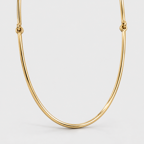 Front view of an 18K yellow gold omega necklace showing its curved center and connecting rings.