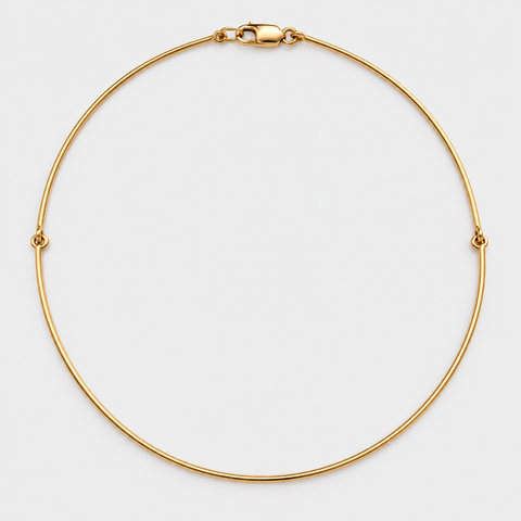 Full view of an 18K yellow gold omega necklace with a lobster clasp on a white background.