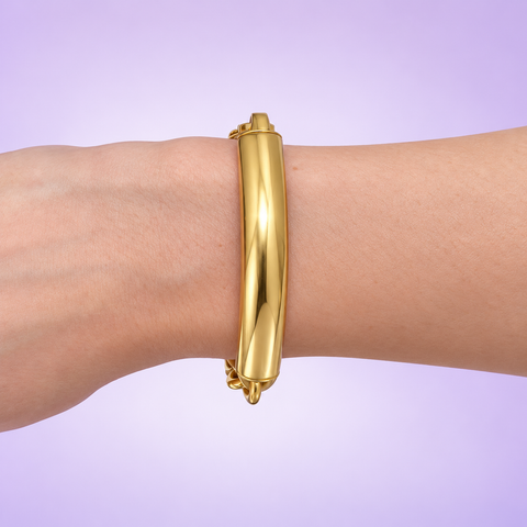 18K yellow gold tubular bar rolo bracelet worn on a wrist against a lavender background.