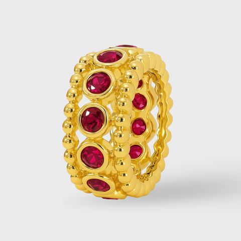 Bezel ruby rondelle in 14K gold featuring 11 round rubies framed by polished gold beading