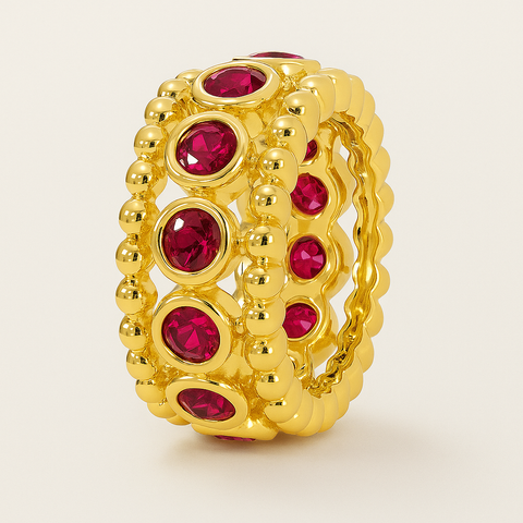 Bezel ruby rondelle in 14K gold featuring 11 round rubies framed by polished gold beading