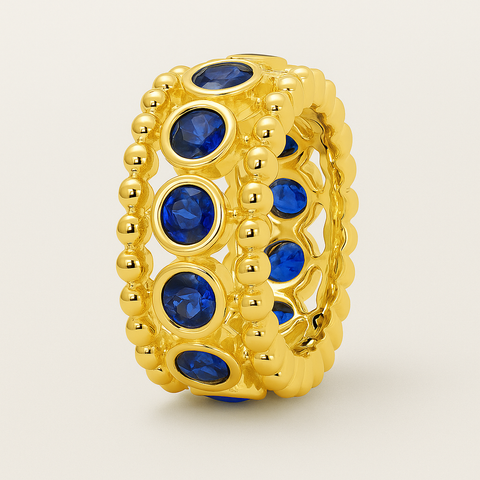 Bezel sapphire rondelle in 14K gold featuring 11 round blue sapphires framed by polished gold beading
