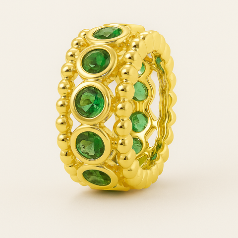 Bezel tsavorite rondelle in 14K gold featuring 11 round green tsavorites framed by polished gold beading.