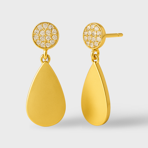 Gold earrings with teardrop design and diamond-like stones on a light gray background