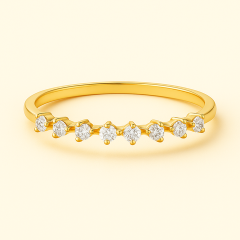 Close-up of 14K yellow gold diamond contour band with eight prong-set round white diamonds on a slim polished band flat