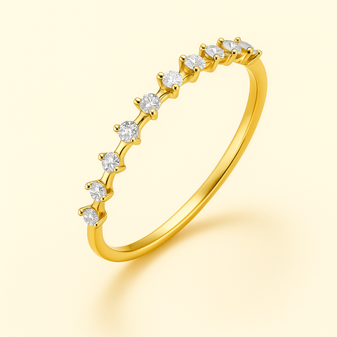 Close-up of 14K yellow gold diamond contour band with eight prong-set round white diamonds on a slim polished band floating