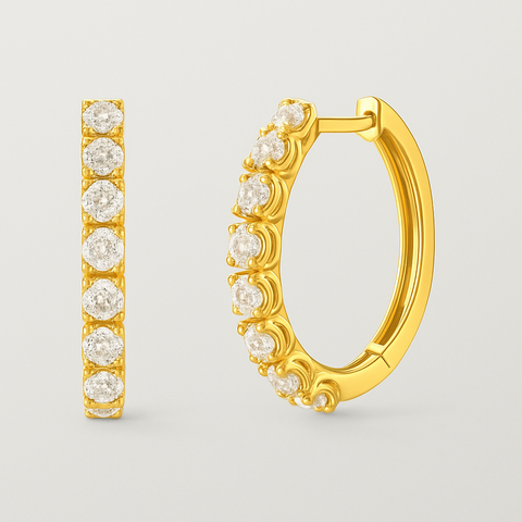 Diamond huggie hoop earrings in 14K gold with pavé-set round white diamonds and polished oval design.