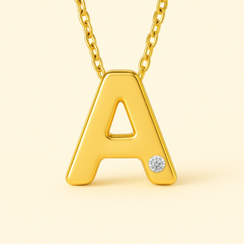 Close-up of 14K gold initial pendant necklace with diamond accent and polished finish.