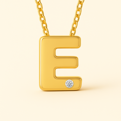 Close-up of 14K gold initial E pendant necklace with diamond accent and polished finish.