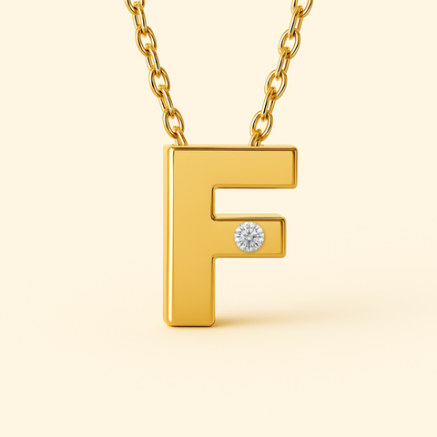 Close-up of 14K gold initial F pendant necklace with diamond accent and polished finish.