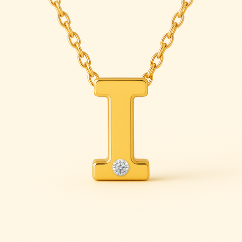 Close-up of 14K gold initial I pendant necklace with diamond accent and polished finish.