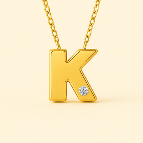 Close-up of 14K gold initial K pendant necklace with diamond accent and polished finish.