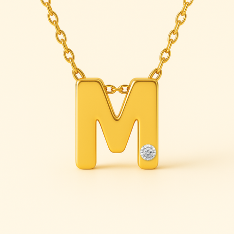 Close-up of 14K gold initial M pendant necklace with diamond accent and polished finish.