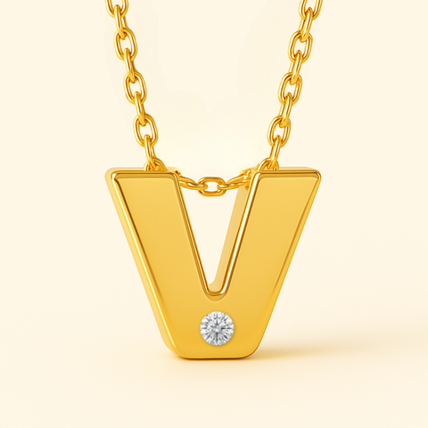 Close-up of 14K gold initial V pendant necklace with diamond accent and polished finish.