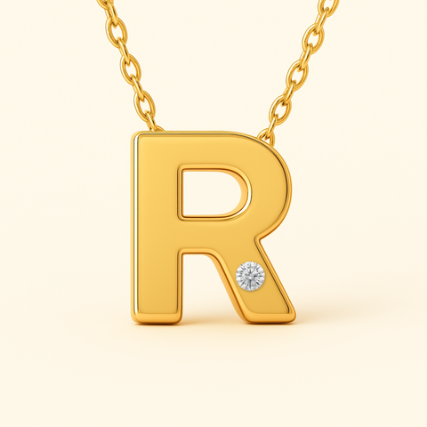Close-up of 14K gold initial R pendant necklace with diamond accent and polished finish.
