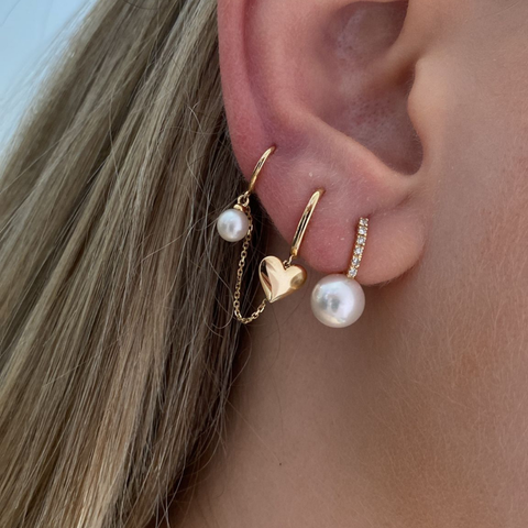 14K Yellow Gold diamond and pearl huggie earrings with round white diamonds, side view