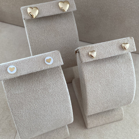 Set of gray jewelry boxes with gold accents on a matching gray background
