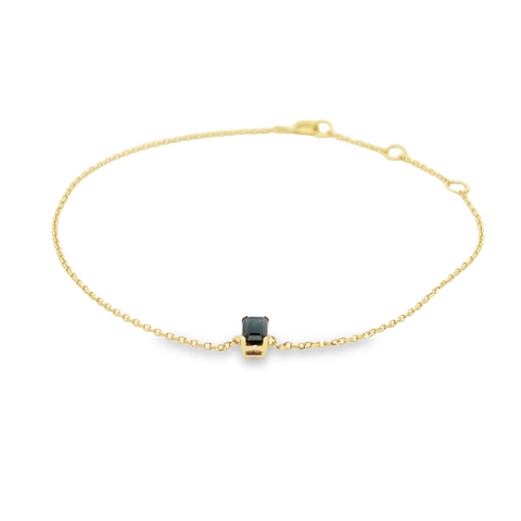 Delicate 14K gold bracelet with a single emerald-cut blue sapphire centerpiece.