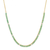 Close-up of 14K gold emerald and diamond tennis necklace with round gemstones.