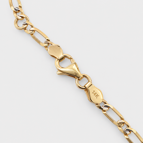 Close-up of the lobster clasp with 14K hallmark on the yellow gold Figaro ID bracelet.