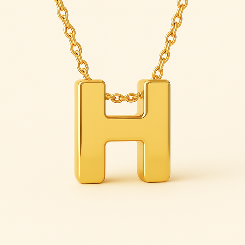 Close-up of 14K gold initial H pendant necklace with polished finish on adjustable chain.