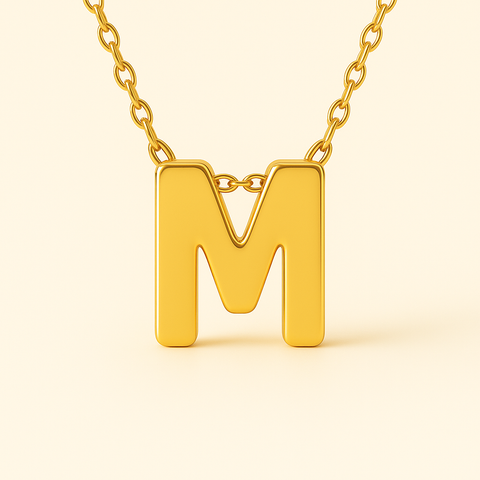 Close-up of 14K gold initial M pendant necklace with polished finish on adjustable chain.