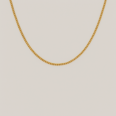 Close up of curve link chain in 18kt yellow gold with soft gray background