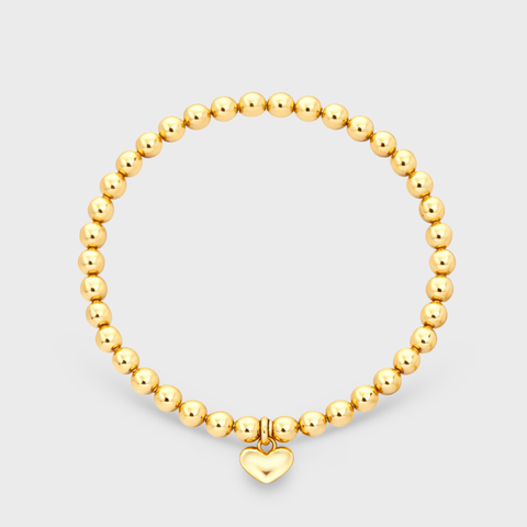 14K yellow gold heart charm elastic bead bracelet flat view showing approximately 38 smooth round gold beads and hanging puffy gold heart charm