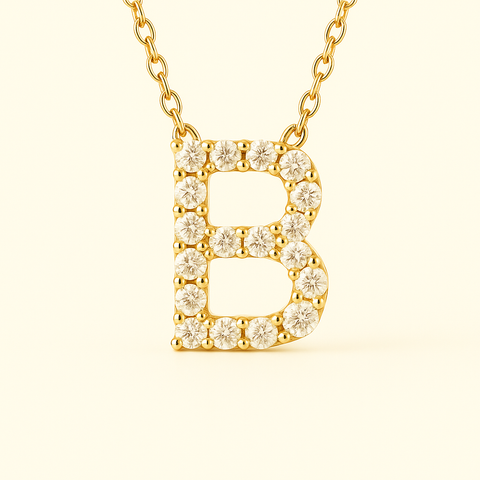 Close-up of 14K gold pavé diamond initial B pendant necklace with fine chain.