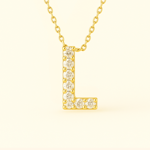 Close-up of 14K gold pavé diamond initial L pendant necklace with fine chain.