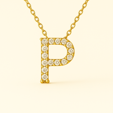 Close-up of 14K gold pavé diamond initial P pendant necklace with fine chain.