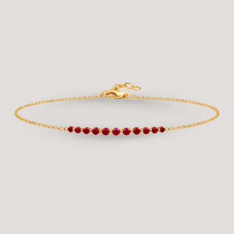 14K yellow gold bar bracelet featuring 11 round rubies on an adjustable fine gold chain.